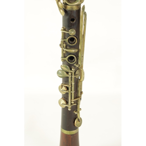 100 - A VINTAGE ROSEWOOD BESSON CLARINET with metal mounts to the bell and banded decoration to each secti... 