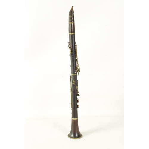 100 - A VINTAGE ROSEWOOD BESSON CLARINET with metal mounts to the bell and banded decoration to each secti... 