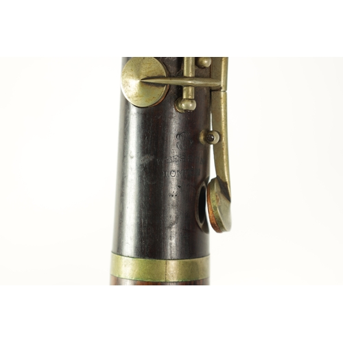 100 - A VINTAGE ROSEWOOD BESSON CLARINET with metal mounts to the bell and banded decoration to each secti... 