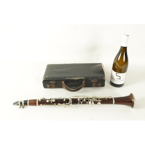 102 - A VINTAGE ROSEWOOD CLARINET with silvered fittings and banded mounts in fitted blue velvet-lined lea... 