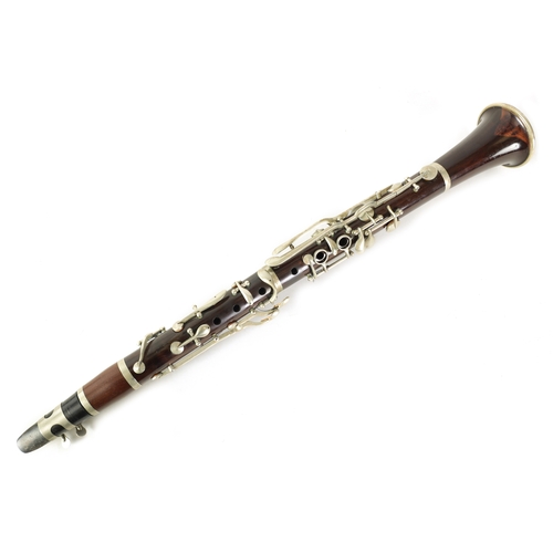 102 - A VINTAGE ROSEWOOD CLARINET with silvered fittings and banded mounts in fitted blue velvet-lined lea... 