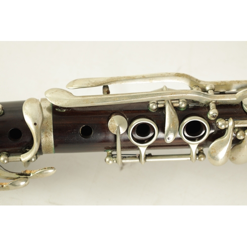 102 - A VINTAGE ROSEWOOD CLARINET with silvered fittings and banded mounts in fitted blue velvet-lined lea... 