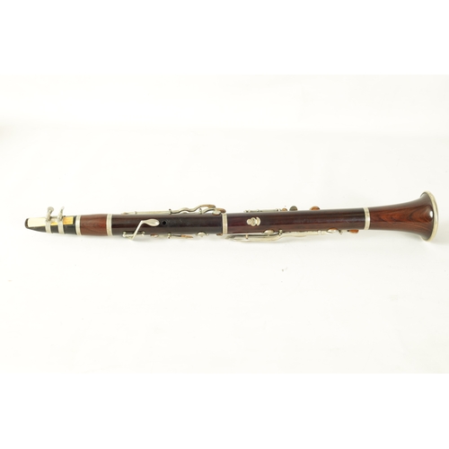 102 - A VINTAGE ROSEWOOD CLARINET with silvered fittings and banded mounts in fitted blue velvet-lined lea... 