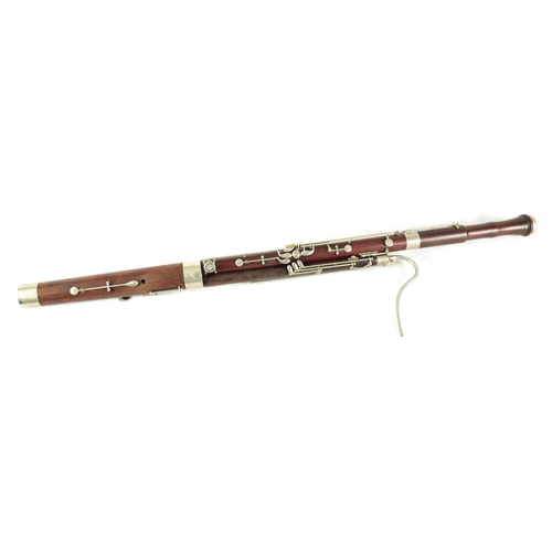 106 - AN EARLY 20TH CENTURY HAWKES & SON LONDON, EXCELSIOR SONORUS CLASS HARDWOOD BASSOON numbered 15491 L... 