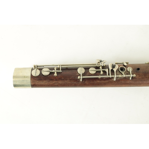 106 - AN EARLY 20TH CENTURY HAWKES & SON LONDON, EXCELSIOR SONORUS CLASS HARDWOOD BASSOON numbered 15491 L... 