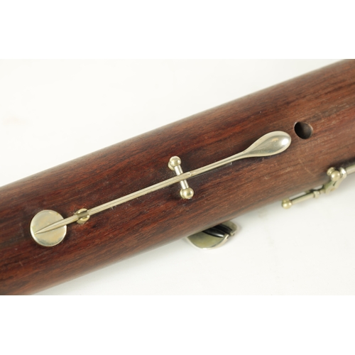 106 - AN EARLY 20TH CENTURY HAWKES & SON LONDON, EXCELSIOR SONORUS CLASS HARDWOOD BASSOON numbered 15491 L... 