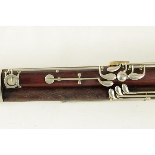 106 - AN EARLY 20TH CENTURY HAWKES & SON LONDON, EXCELSIOR SONORUS CLASS HARDWOOD BASSOON numbered 15491 L... 