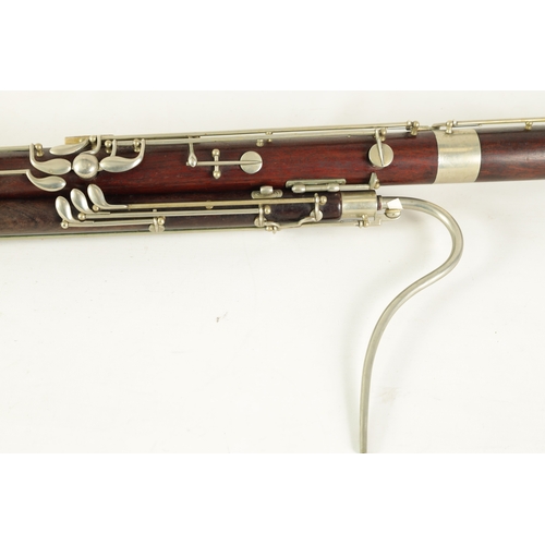 106 - AN EARLY 20TH CENTURY HAWKES & SON LONDON, EXCELSIOR SONORUS CLASS HARDWOOD BASSOON numbered 15491 L... 