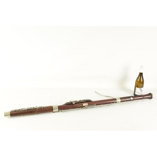 106 - AN EARLY 20TH CENTURY HAWKES & SON LONDON, EXCELSIOR SONORUS CLASS HARDWOOD BASSOON numbered 15491 L... 