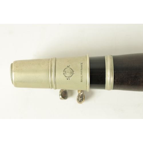 135 - A VINTAGE EBONY MARTIN DARDART CLARINET the turned corked segmented body with metal banded details a... 