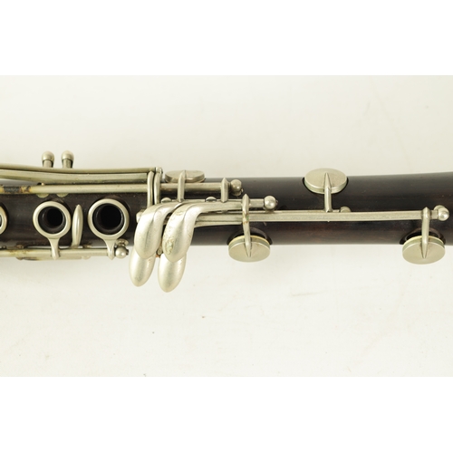 135 - A VINTAGE EBONY MARTIN DARDART CLARINET the turned corked segmented body with metal banded details a... 