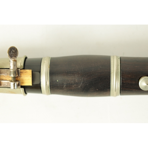 135 - A VINTAGE EBONY MARTIN DARDART CLARINET the turned corked segmented body with metal banded details a... 