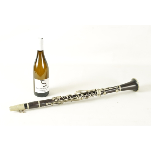 135 - A VINTAGE EBONY MARTIN DARDART CLARINET the turned corked segmented body with metal banded details a... 