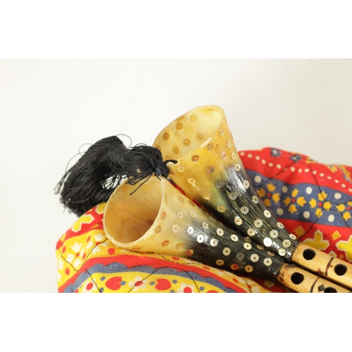 137 - A SET OF MIZOUED TUNISIAN BAGPIPES with horn pipes and leather bag.(39cm overall)