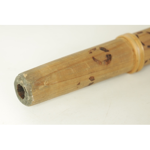 138 - A BAMBOO TAPERING WOOD TRUMPET with scorched ringed decoration.(154cm overall)