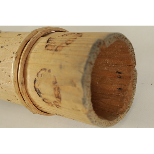 138 - A BAMBOO TAPERING WOOD TRUMPET with scorched ringed decoration.(154cm overall)