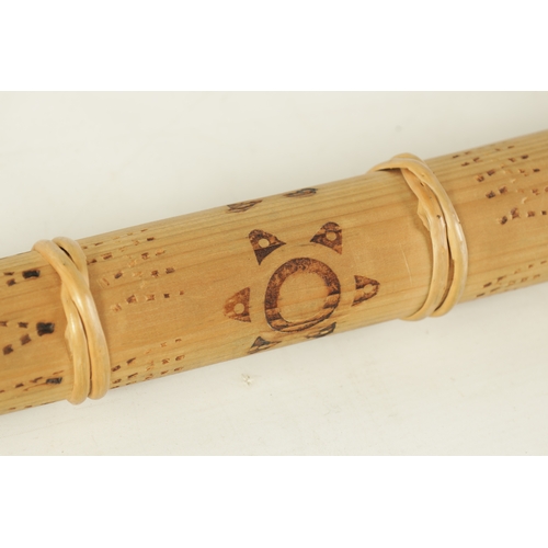 138 - A BAMBOO TAPERING WOOD TRUMPET with scorched ringed decoration.(154cm overall)