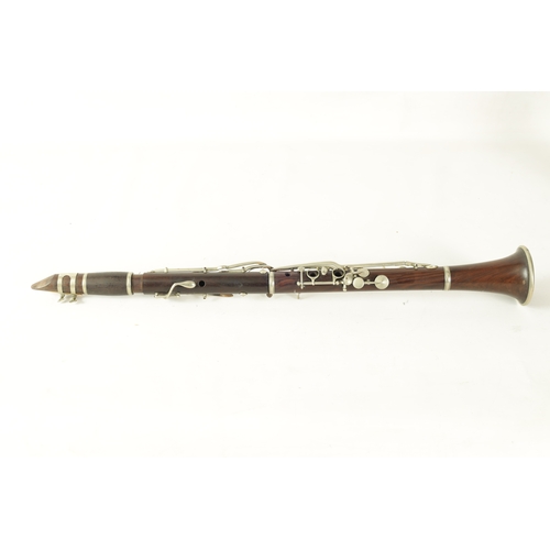 141 - A MID 20TH CENTURY MOUNTED ROSEWOOD CLARINET IN B of segmented design with metal collard and all fit... 