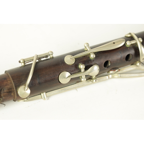 141 - A MID 20TH CENTURY MOUNTED ROSEWOOD CLARINET IN B of segmented design with metal collard and all fit... 