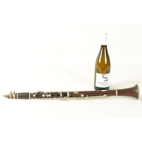 141 - A MID 20TH CENTURY MOUNTED ROSEWOOD CLARINET IN B of segmented design with metal collard and all fit... 