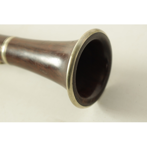 141 - A MID 20TH CENTURY MOUNTED ROSEWOOD CLARINET IN B of segmented design with metal collard and all fit... 