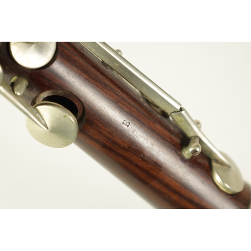 141 - A MID 20TH CENTURY MOUNTED ROSEWOOD CLARINET IN B of segmented design with metal collard and all fit... 