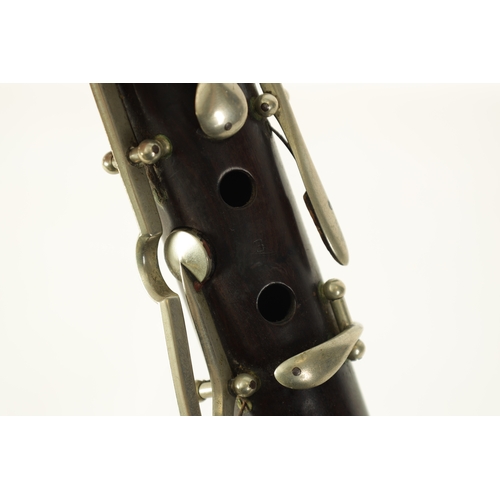 141 - A MID 20TH CENTURY MOUNTED ROSEWOOD CLARINET IN B of segmented design with metal collard and all fit... 