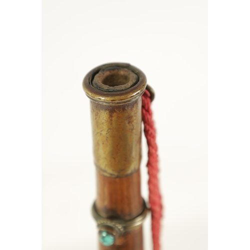 143 - A TIBETAN GAYALING RITUAL TRUMPET having brass rings set with turquoise and coral mounts(52cm overal... 