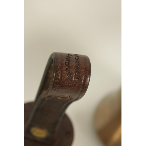 147 - A SET OF 12 HAND BELLS SIGNED WARNER, LONDON with leather strap handles having star punch decoration... 