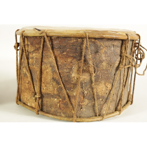 148 - A VINTAGE SNAKE SKIN TAMBOURINE TOGETHER WITH A BARK DRUM(27cm & 17cm diameter)