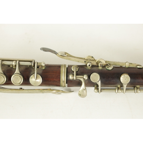 153 - A LATE 19TH CENTURY SLENDER ROSEWOOD OBOE with metal banded detail to the body and all fittings.(55c... 