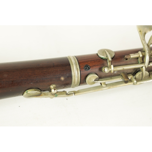 153 - A LATE 19TH CENTURY SLENDER ROSEWOOD OBOE with metal banded detail to the body and all fittings.(55c... 