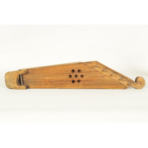 21 - A KANTELE BY CARLO BERGMAN, FINLAND fitted five wire strings, pierced circular sound frets and scrol... 