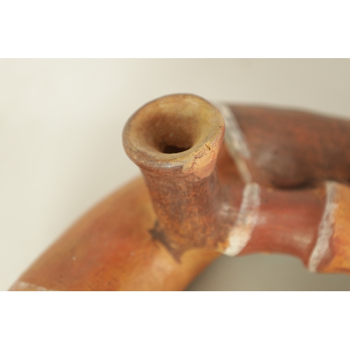 4 - TWO PERUVIAN HORNS Both of sectional form, the larger made of cow horn with leather binding to the j... 