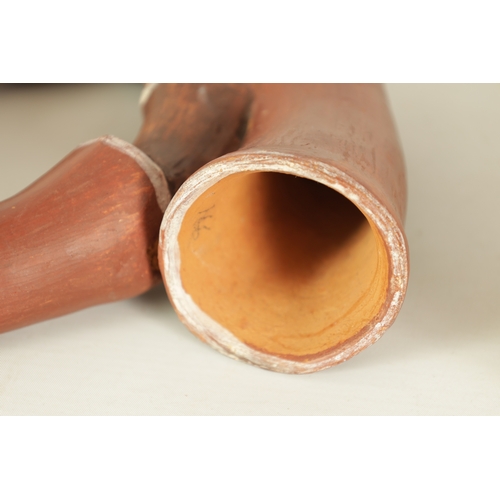 4 - TWO PERUVIAN HORNS Both of sectional form, the larger made of cow horn with leather binding to the j... 