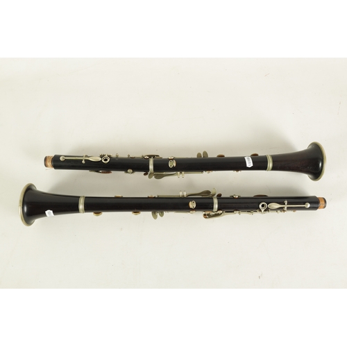 54 - TWO EARLY 20TH CENTURY BUFFET CLARINETS turned in ebony with nickel buttons and impressed makers mar... 