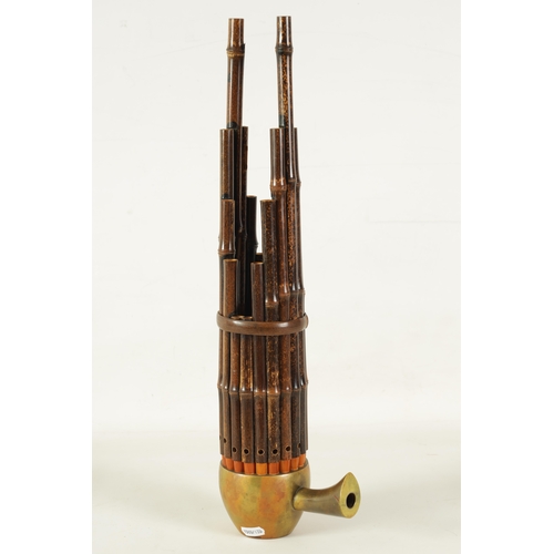 60 - A LATE 19TH CENTURY CHINESE SHENG with brass bowl and mouth piece fitted graduated bamboo pipes.(49.... 