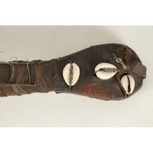 7 - A WEST AFRICAN TRIBAL KORA LOUTE with shell decoration and skin covered body.(72cm overall)... 