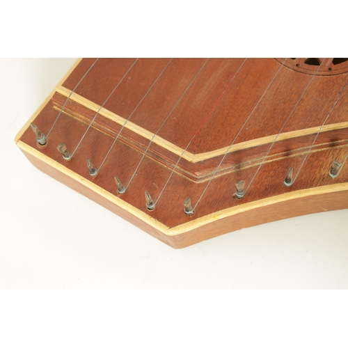 87 - A 20TH CENTURY HARDWOOD DULCIMER BY PETER ECKER DATED 1970 of shaped form with pierced sound frets, ... 