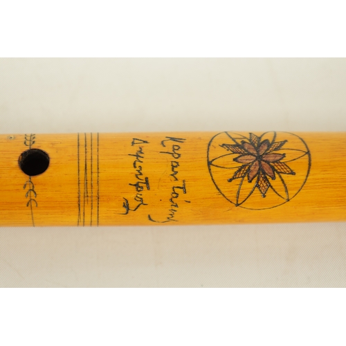 9 - A LATE 20TH CENTURY GREEK BAMBOO FLUTE having 8 finger holes, bands of engraved decoration, flowerhe... 