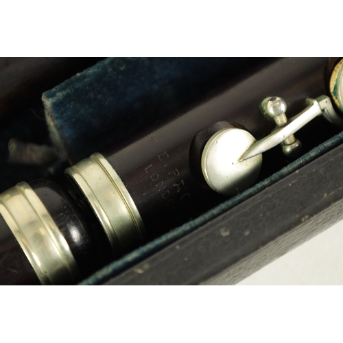 97 - A CASED ROSEWOOD CLASS A FLUTE BY T.E. PAGE, LONDON. The five section flute having nickel buttons an... 