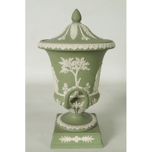 110 - A WEDGWOOD GREEN JASPER WARE TWO-HANDLED URN SHAPED VASE AND COVER ON PEDESTAL BASE decorated with a... 