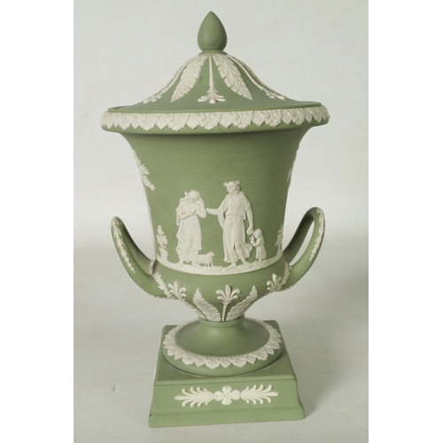 110 - A WEDGWOOD GREEN JASPER WARE TWO-HANDLED URN SHAPED VASE AND COVER ON PEDESTAL BASE decorated with a... 