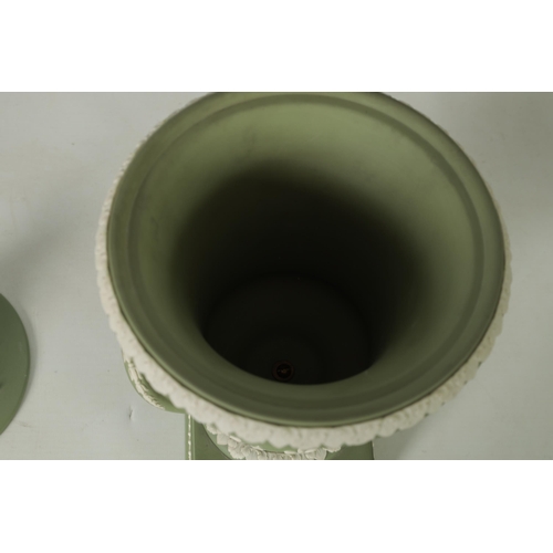 110 - A WEDGWOOD GREEN JASPER WARE TWO-HANDLED URN SHAPED VASE AND COVER ON PEDESTAL BASE decorated with a... 