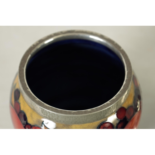 118 - A 1930's/40's WILLIAM MOORCROFT OVOID BISCUIT JAR with hammered pewter mount and domed lid, tube lin... 