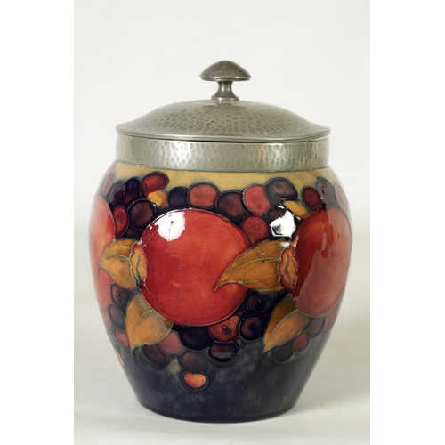 118 - A 1930's/40's WILLIAM MOORCROFT OVOID BISCUIT JAR with hammered pewter mount and domed lid, tube lin... 