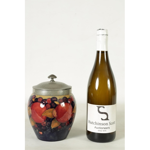118 - A 1930's/40's WILLIAM MOORCROFT OVOID BISCUIT JAR with hammered pewter mount and domed lid, tube lin... 