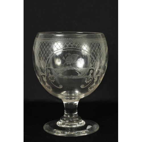 17 - AN OVERSIZED LATE GEORGIAN GLASS GOBLET the rounded bowl with frosted and cut engraved panels of coc... 