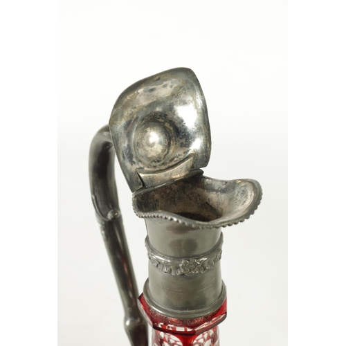 24 - A 19TH CENTURY BOHEMIAN GLASS CLARET JUG of cut red glass overlay design with pewter mounts. (27cm h... 