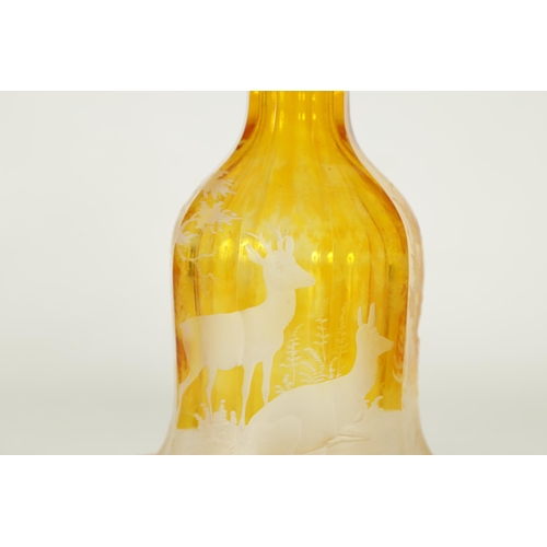 3 - A FINE PAIR OF 19TH CENTURY BOHEMIAN AMBER FLASHED GLASS DECANTERS decorated with Stags amongst wood... 